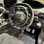 Peugeot car showing over-ring and push-down handbrake mechanism Image